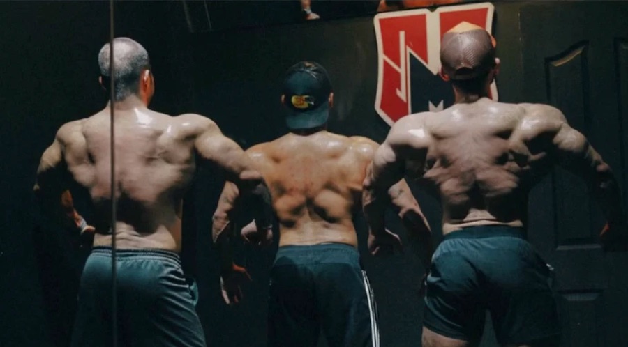 Bodybuilder training back under load
